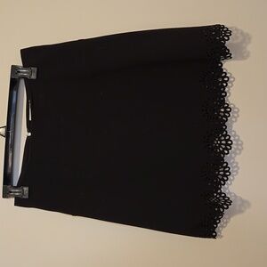 Two A-line black petite skirts